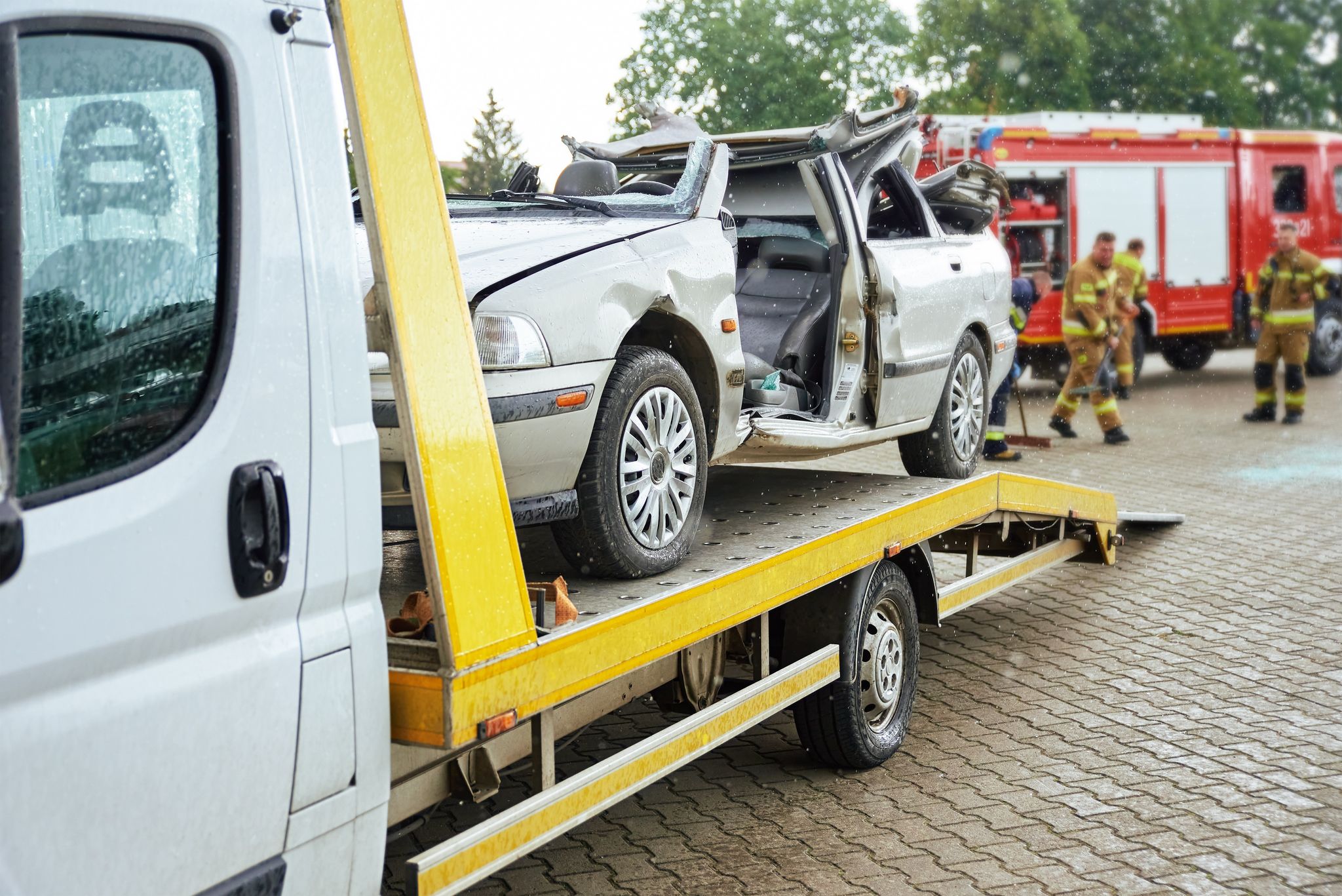 Wrecked car loading on tow truck after crash traffic accident